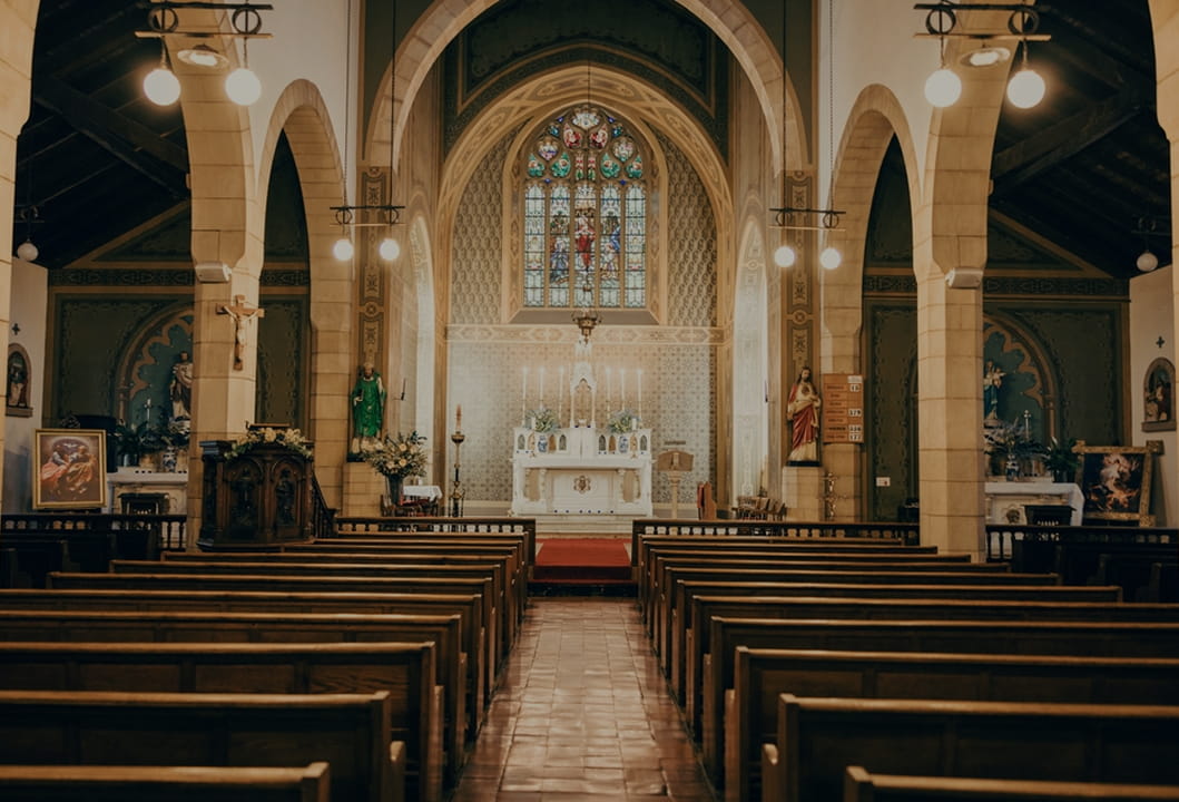 church sanctuary with pews, altar, and traditional worship space design 