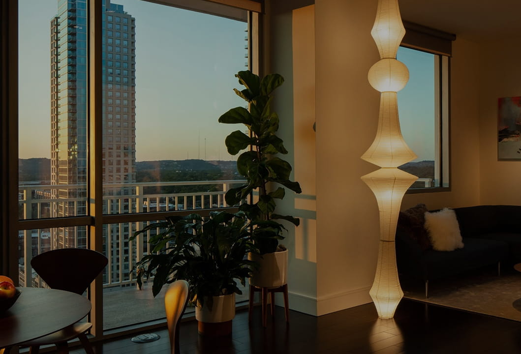 high-rise apartment view from a furnished residence with decorative interior lighting