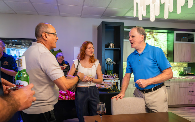 A Liaison Technology Group team member guides guests through the Fort Myers Design Center bedroom technology display